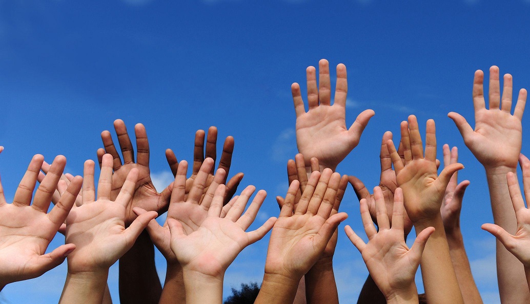 volunteer group raising hands